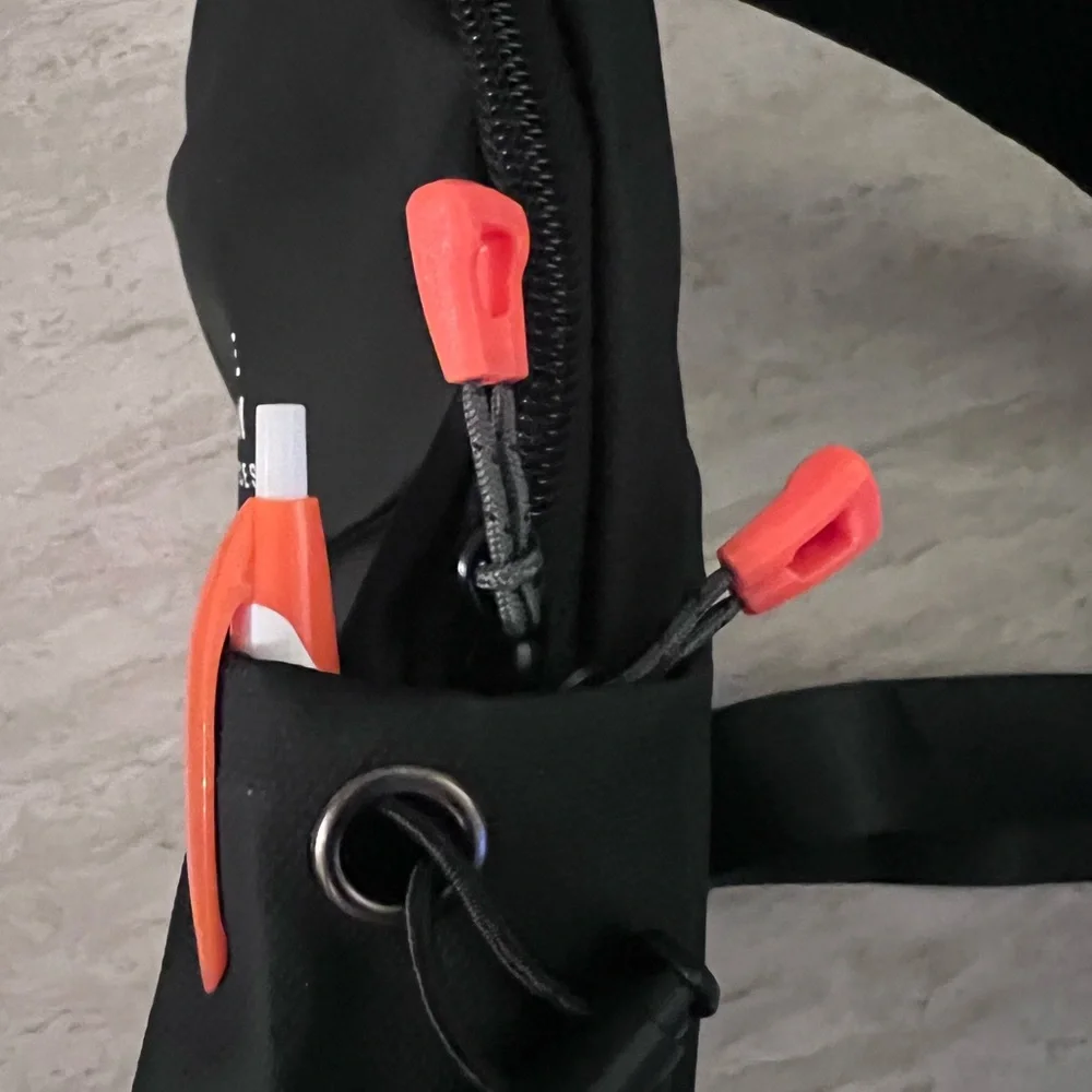 Waterproof Travel Sling Bag- Unisex. Black with Orange accents.